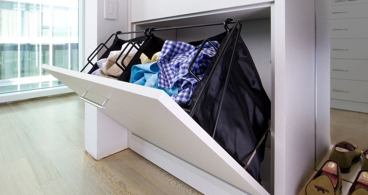 Pull out hamper in classic white wood grain finish designed by California Closets