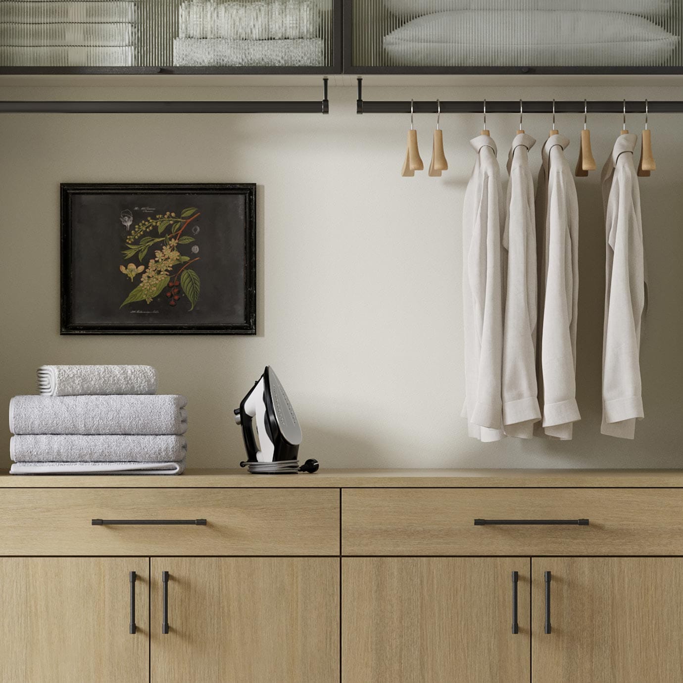 Small laundry room with cabinets and countertop folding area by California Closets