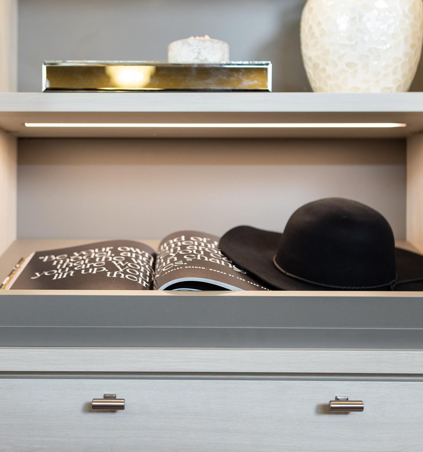 Custom closet organizing drawers and lighted shelving from California Closets