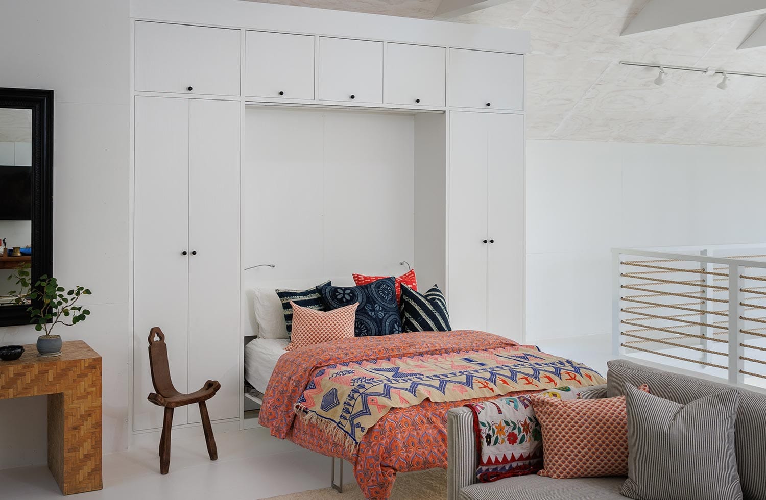 Custom wall bed with cabinets for storage in white finish by California Closets